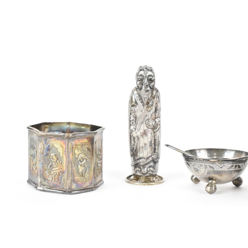 115 - A small collection of Oriental export white metal, comprising a Chinese silver figural salt shaker, ... 