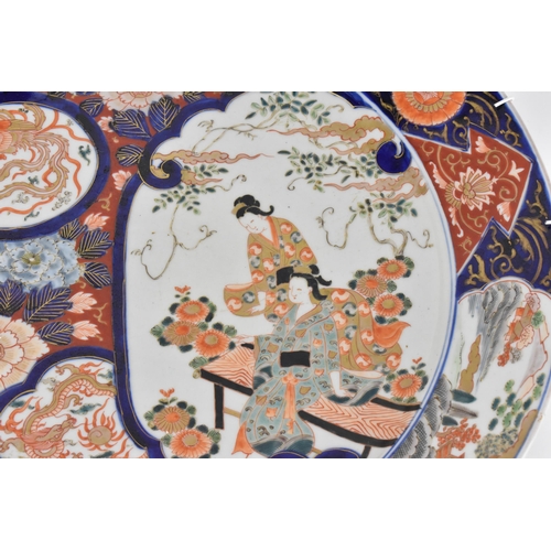 118 - A large Japanese imari charger, Meiji period, in traditional blue and red palette with alternating s... 