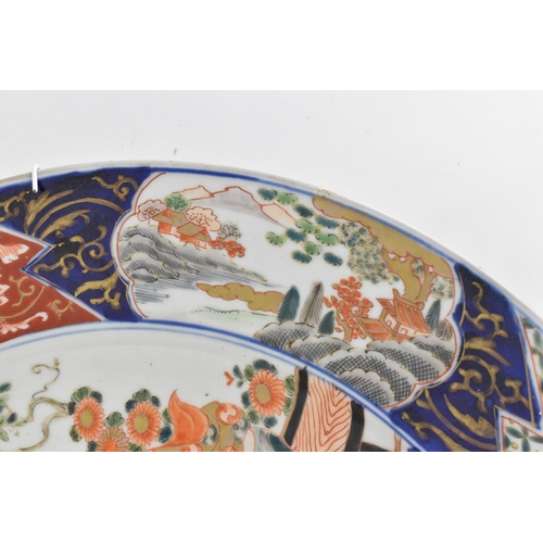 118 - A large Japanese imari charger, Meiji period, in traditional blue and red palette with alternating s... 