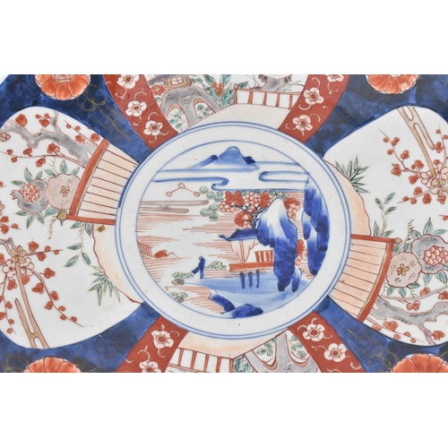 118 - A large Japanese imari charger, Meiji period, in traditional blue and red palette with alternating s... 