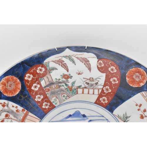 118 - A large Japanese imari charger, Meiji period, in traditional blue and red palette with alternating s... 