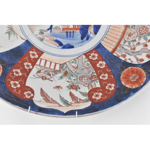 118 - A large Japanese imari charger, Meiji period, in traditional blue and red palette with alternating s... 