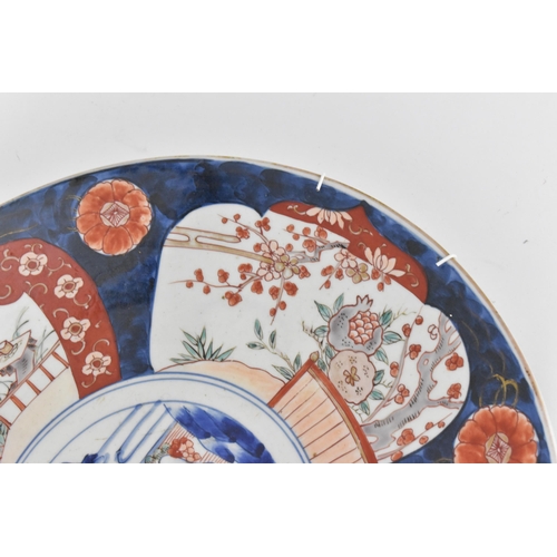 118 - A large Japanese imari charger, Meiji period, in traditional blue and red palette with alternating s... 