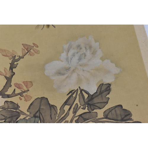 119 - A Chinese watercolour on silk scroll painting of peonies, inscribed and with red seal mark to right ... 