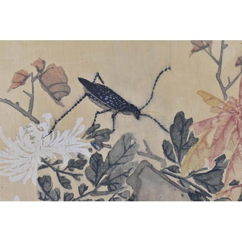 120 - A Chinese watercolour on silk scroll painting of chrysanthemums, inscribed and with red seal mark to... 