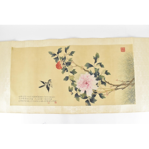 121 - A 20th century Chinese watercolour on silk scroll painting of peonies and bird, inscribed and with r... 