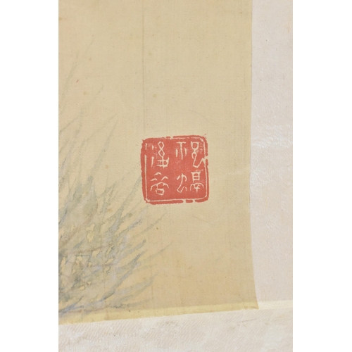 121 - A 20th century Chinese watercolour on silk scroll painting of peonies and bird, inscribed and with r... 