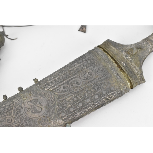 194 - A white metal mounted jambiya and sheath, probably Omani, together with a Peruvian white metal clad ... 