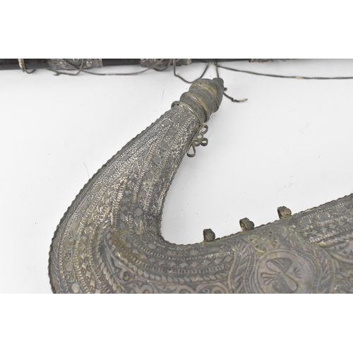 194 - A white metal mounted jambiya and sheath, probably Omani, together with a Peruvian white metal clad ... 