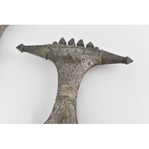 194 - A white metal mounted jambiya and sheath, probably Omani, together with a Peruvian white metal clad ... 