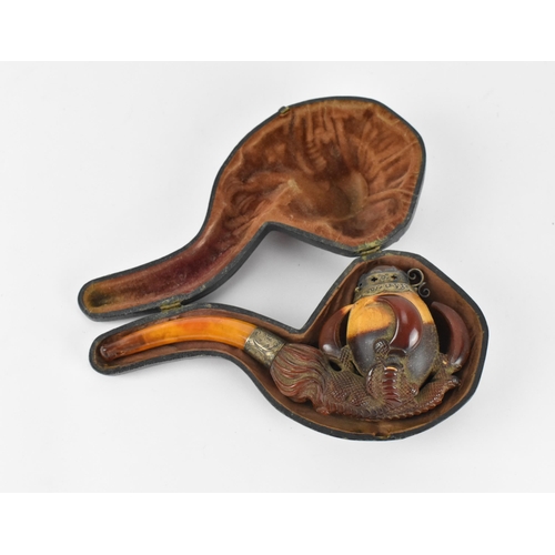 195 - A large Meerschaum pipe carved in the form of a bird’s claw, with silver mounted amber cover and amb... 