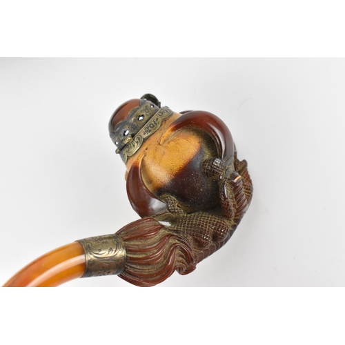 195 - A large Meerschaum pipe carved in the form of a bird’s claw, with silver mounted amber cover and amb... 