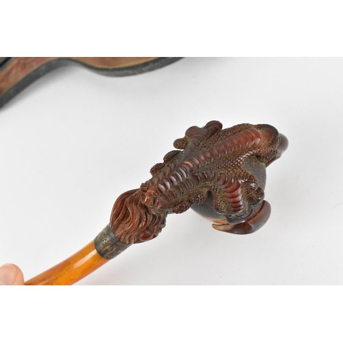 195 - A large Meerschaum pipe carved in the form of a bird’s claw, with silver mounted amber cover and amb... 