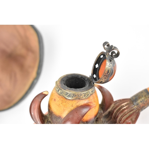 195 - A large Meerschaum pipe carved in the form of a bird’s claw, with silver mounted amber cover and amb... 