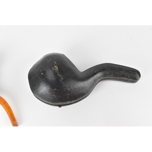 195 - A large Meerschaum pipe carved in the form of a bird’s claw, with silver mounted amber cover and amb... 