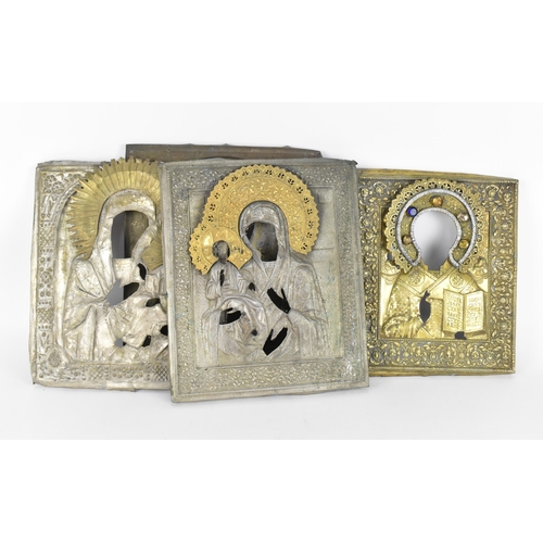 196 - A small collection of Russian icon oklads (or riza), to include a very ornate brass example with emb... 