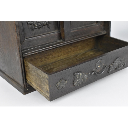 73 - A Japanese Meiji period table top cabinet, late 19th century, in dark oak, with two short drawers ab... 