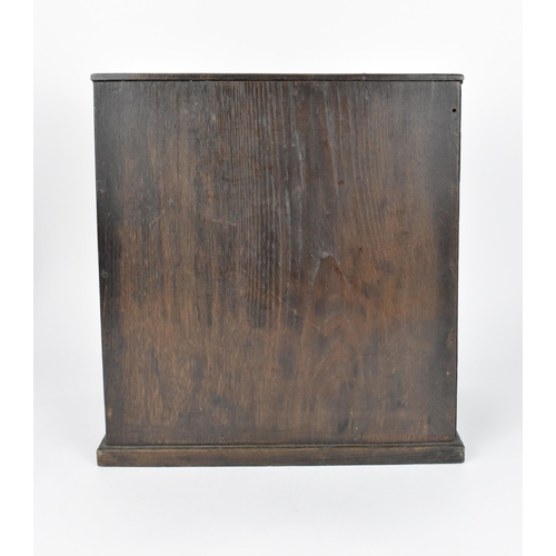 73 - A Japanese Meiji period table top cabinet, late 19th century, in dark oak, with two short drawers ab... 