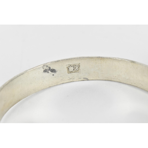 80 - A set of three Chinese white metal torque bangles, with stamped character hallmark, designed with dr... 