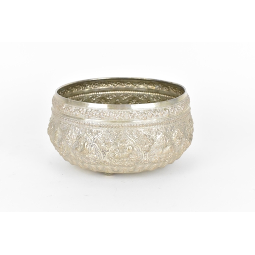 83 - An Indian colonial export white metal cutch bowl, of circular form with profusely embossed foliage, ... 