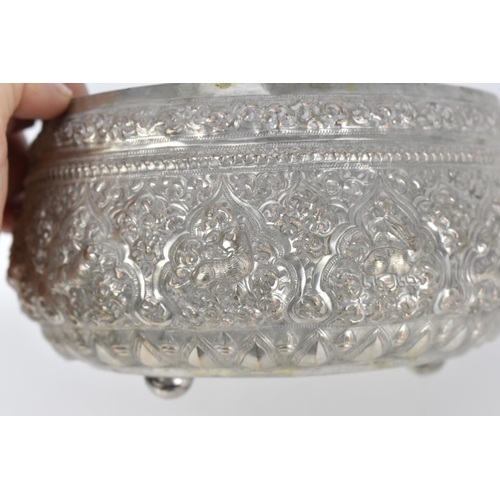 83 - An Indian colonial export white metal cutch bowl, of circular form with profusely embossed foliage, ... 