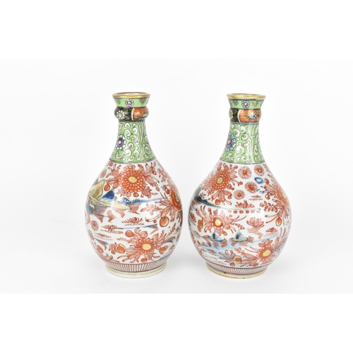 84 - A pair of 19th century Imari porcelain vases, of bottle vase shape with knopped necks, the top appli... 