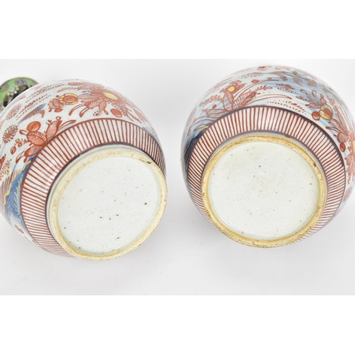 84 - A pair of 19th century Imari porcelain vases, of bottle vase shape with knopped necks, the top appli... 