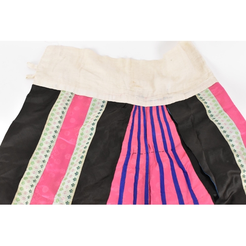 97 - A Chinese Han embroidered silk qun/skirt, late 19th/early 20th century, in pink, blue and black, wit... 