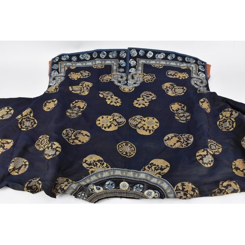 98 - A Chinese Qing dynasty embroidered silk jacket, in navy with gilt roundels and floral details to the... 