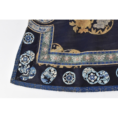 98 - A Chinese Qing dynasty embroidered silk jacket, in navy with gilt roundels and floral details to the... 