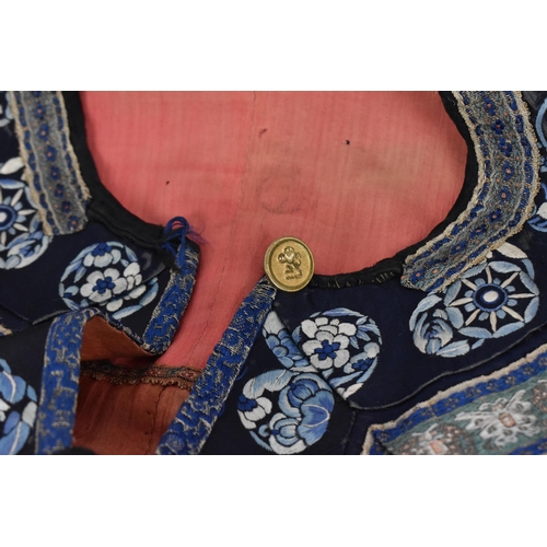 98 - A Chinese Qing dynasty embroidered silk jacket, in navy with gilt roundels and floral details to the... 