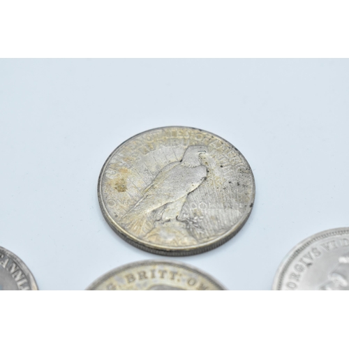 152 - A group of mixed British and American coinage to include a 1821 crown 1921 Morgan Dollar, a pair of ... 