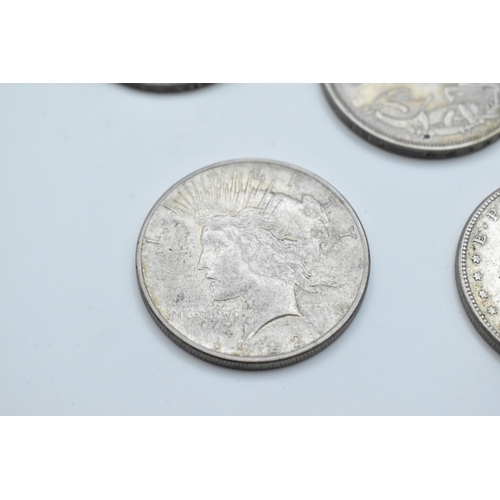 152 - A group of mixed British and American coinage to include a 1821 crown 1921 Morgan Dollar, a pair of ... 