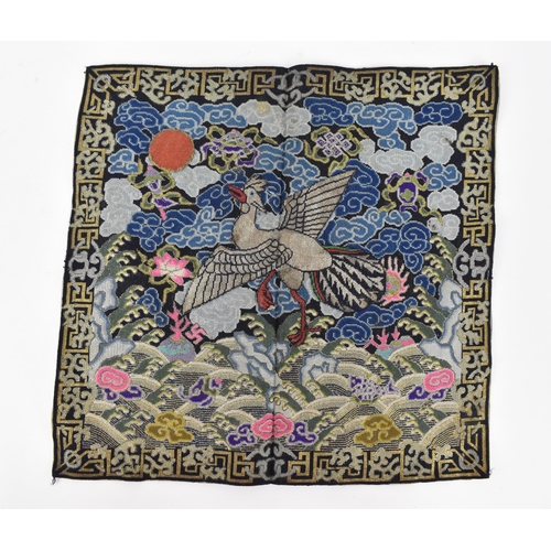 102A - A Chinese Qing dynasty kesi tapestry rank badge, embroidered with mandarin duck facing the sun on a ... 