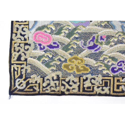 102A - A Chinese Qing dynasty kesi tapestry rank badge, embroidered with mandarin duck facing the sun on a ... 