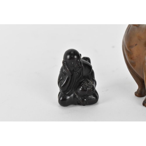 125 - Three Japanese carved wood netsukes, comprising a model of a rat, a tiger and a seated figure, the r... 