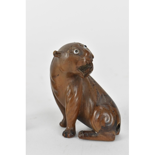 125 - Three Japanese carved wood netsukes, comprising a model of a rat, a tiger and a seated figure, the r... 