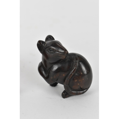 125 - Three Japanese carved wood netsukes, comprising a model of a rat, a tiger and a seated figure, the r... 