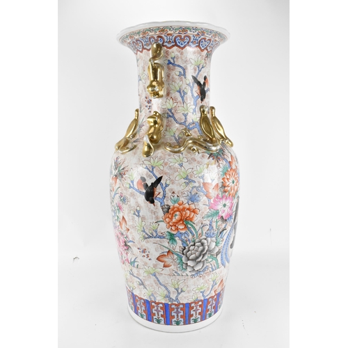 126 - A mid 20th century Chinese floor standing vase, of baluster form with dogs of Foo handles either sid... 