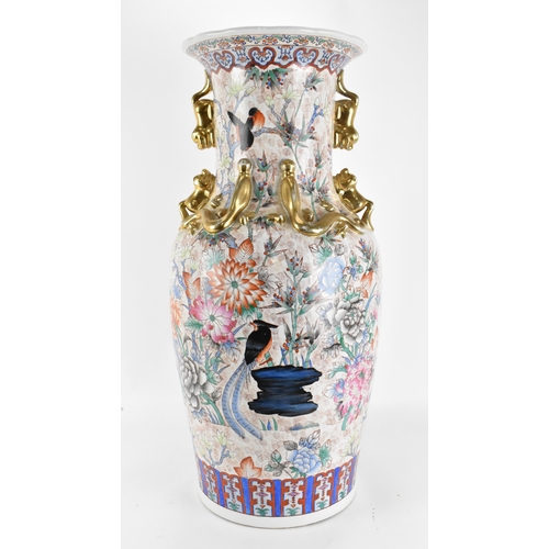 126 - A mid 20th century Chinese floor standing vase, of baluster form with dogs of Foo handles either sid... 