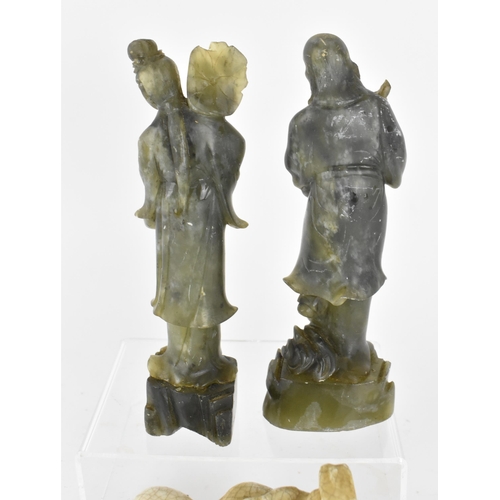 127 - Two Chinese spinach jade figural sculptures, modelled as two of the eight immortals, He Xian Gu and ... 