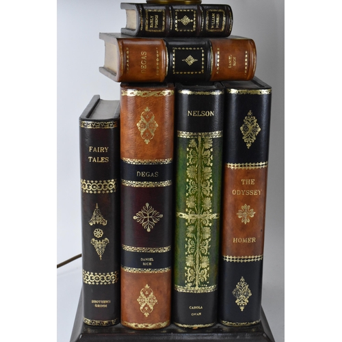 178 - A pair of Maitland-Smith faux book table lamps, with matching chamfered design shades with gilt tool... 