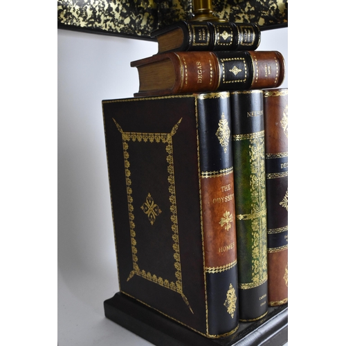 178 - A pair of Maitland-Smith faux book table lamps, with matching chamfered design shades with gilt tool... 