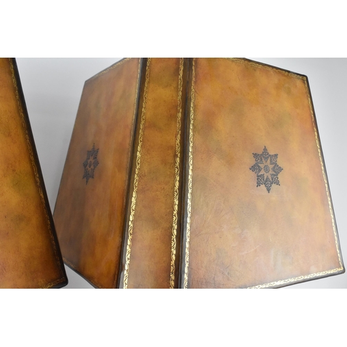 178 - A pair of Maitland-Smith faux book table lamps, with matching chamfered design shades with gilt tool... 