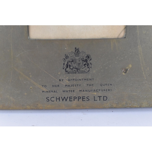 204 - An early 20th century brass Schweppes advertising menu frame, with glazed aperture containing an old... 