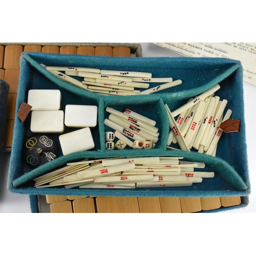 213 - A Chinese leather cased Mahjong bone and bamboo set, the case with four pull out fitted trays holdin... 