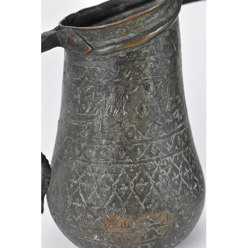 224 - A Middle Eastern Dallah coffee pot, with foliate pattern to the top half,27 cm high, together with a... 