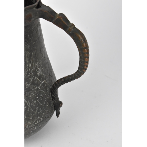 224 - A Middle Eastern Dallah coffee pot, with foliate pattern to the top half,27 cm high, together with a... 