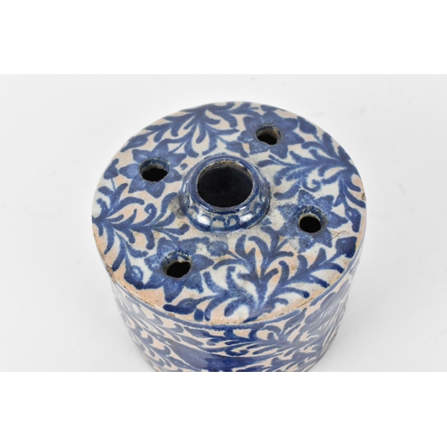 225 - An Ottoman ceramic ink well and pen holder, of cylindrical form with Iznik blue and white foliage de... 