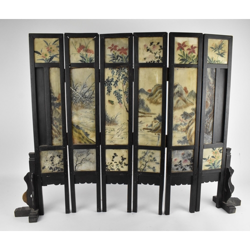 41A - A Chinese Qing Dynasty six-panel table screen, the stone panels with painted figures of women around... 